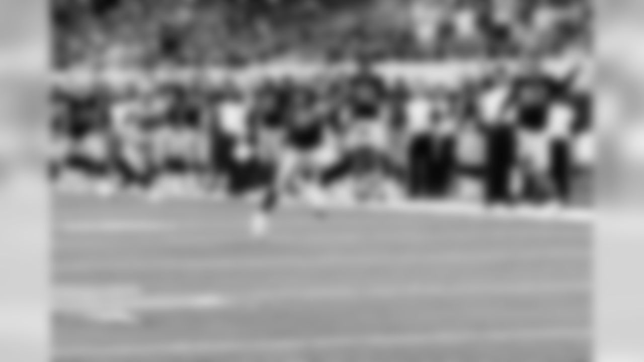 The Raiders bench erupts as safety Jerome Boyd races to paydirt with the game-clinching interception return for a touchdown. Photo by Tony Gonzales.