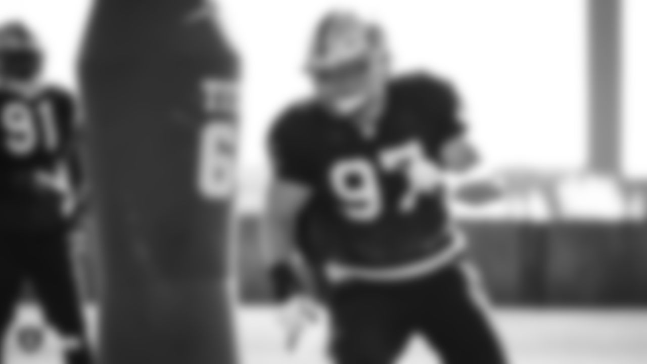 Raiders defensive end Josh Mauro (97) goes through defensive drills during practice.
