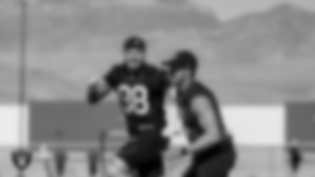 Las Vegas Raiders defensive end Maxx Crosby (98) and quarterback Derek Carr (4) at a workout during phase two of the offseason program.