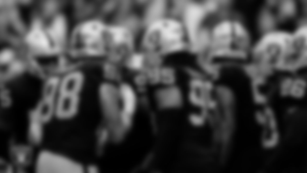 The Las Vegas Raiders defense huddle during the regular season home game against the Arizona Cardinals at Allegiant Stadium.