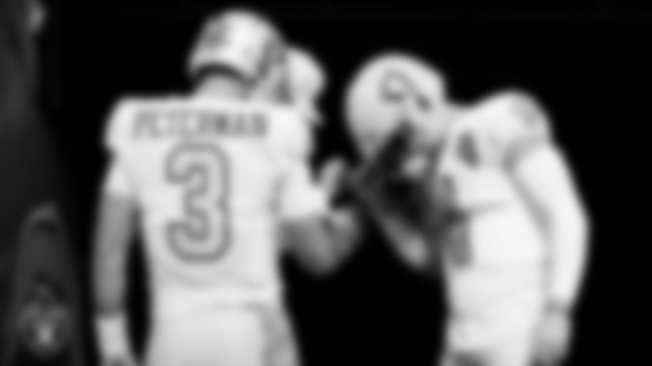 The Raiders quarterbacks huddle before the regular season game against the Los Angeles Chargers at SoFi Stadium.