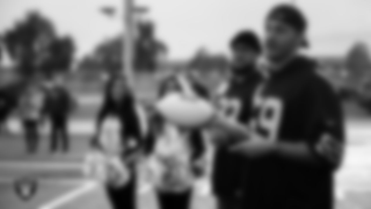 Las Vegas Raiders linebacker Luke Masterson (59) talks to the Mater Academy East flag football team before their coach, Will Brownell, is named the Tom Flores High School Coach of the Week, and Jasmine W. as Most Outstanding Performer.