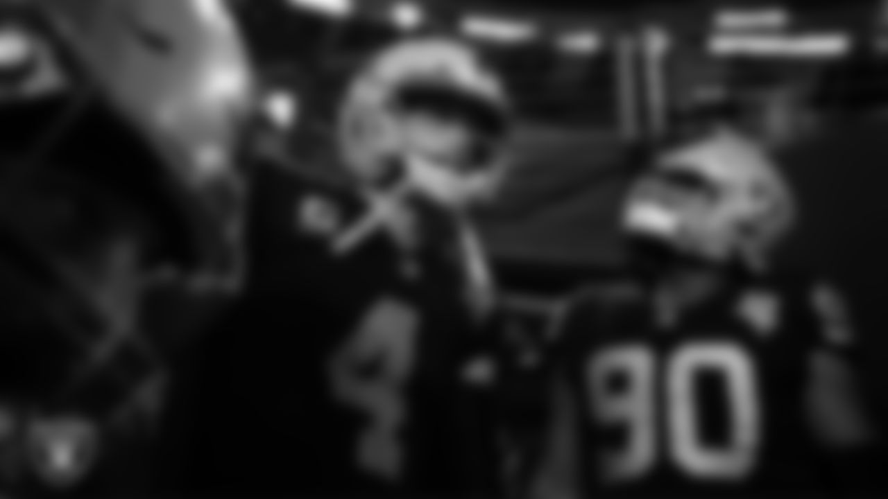 Las Vegas Raiders quarterback Derek Carr (4) and defensive tackle Johnathan Hankins (90) wait to be introduced onto the field before the regular season home game against the Kansas City Chiefs.