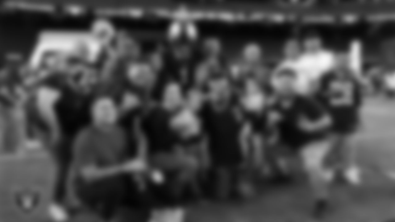 Fans pose for a photo during the Season Ticket Member Appreciation Fan Fest at Allegiant Stadium.