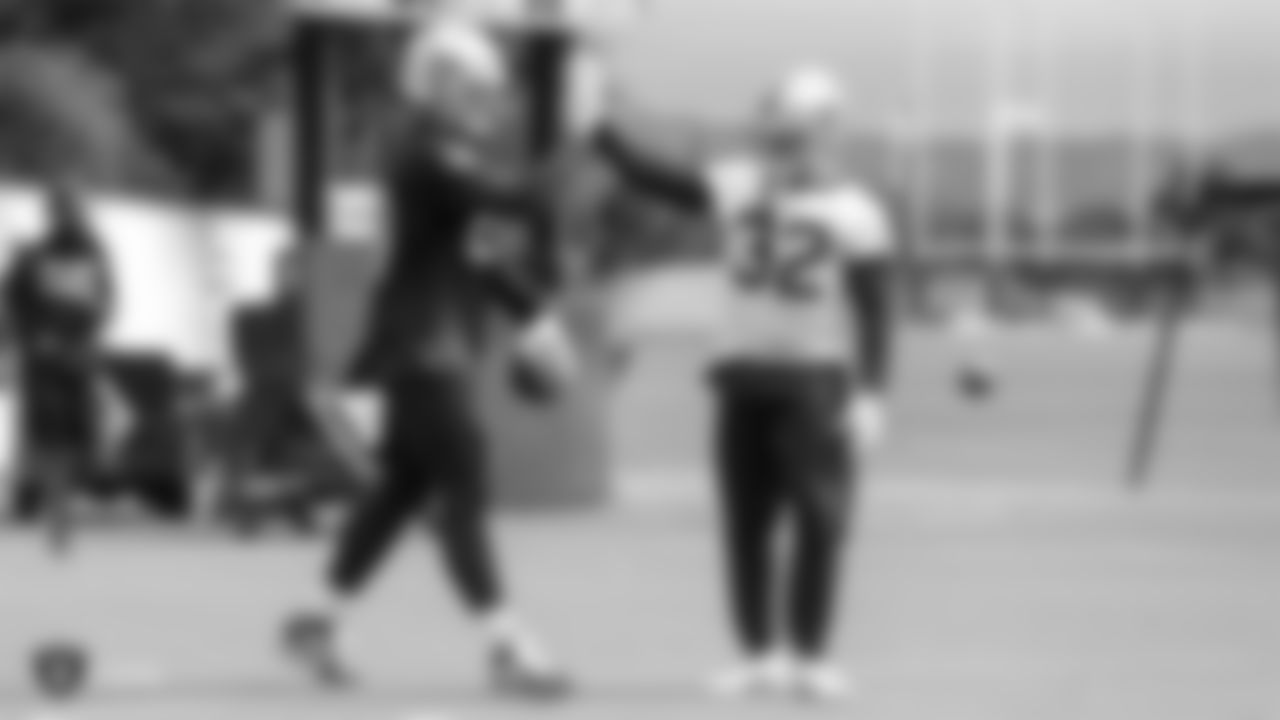Raiders tight end Foster Moreau (87) and safety Dallin Leavitt (32) on the field for practice.