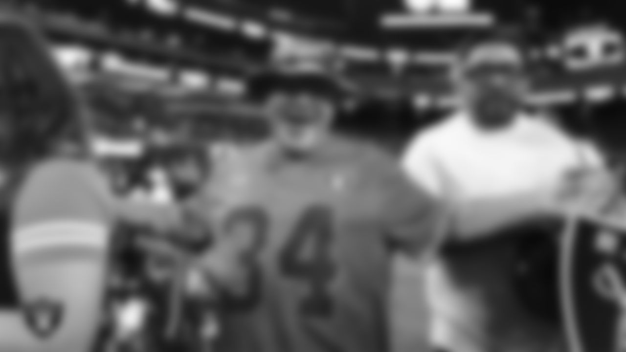 A fan poses for a photo during the Season Ticket Member Appreciation Fan Fest at Allegiant Stadium.
