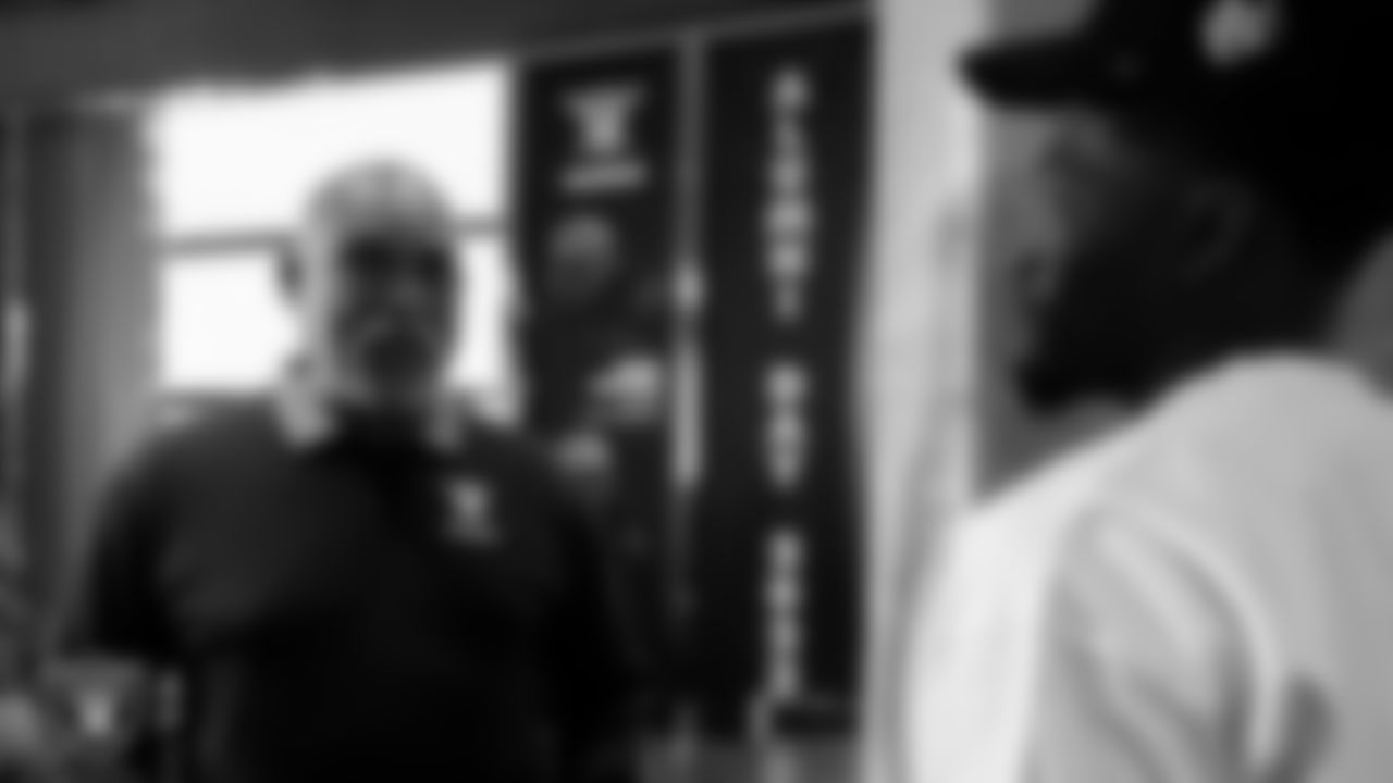 Las Vegas Raiders alumnus Raymond Chester and cornerback Sam Webb (27) speak during an alumni dinner.