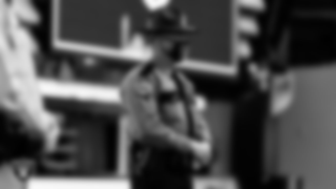A member of the Nevada Highway Patrol waits to light the Al Davis Memorial Torch before the Las Vegas Raiders regular season home game against the Indianapolis Colts.