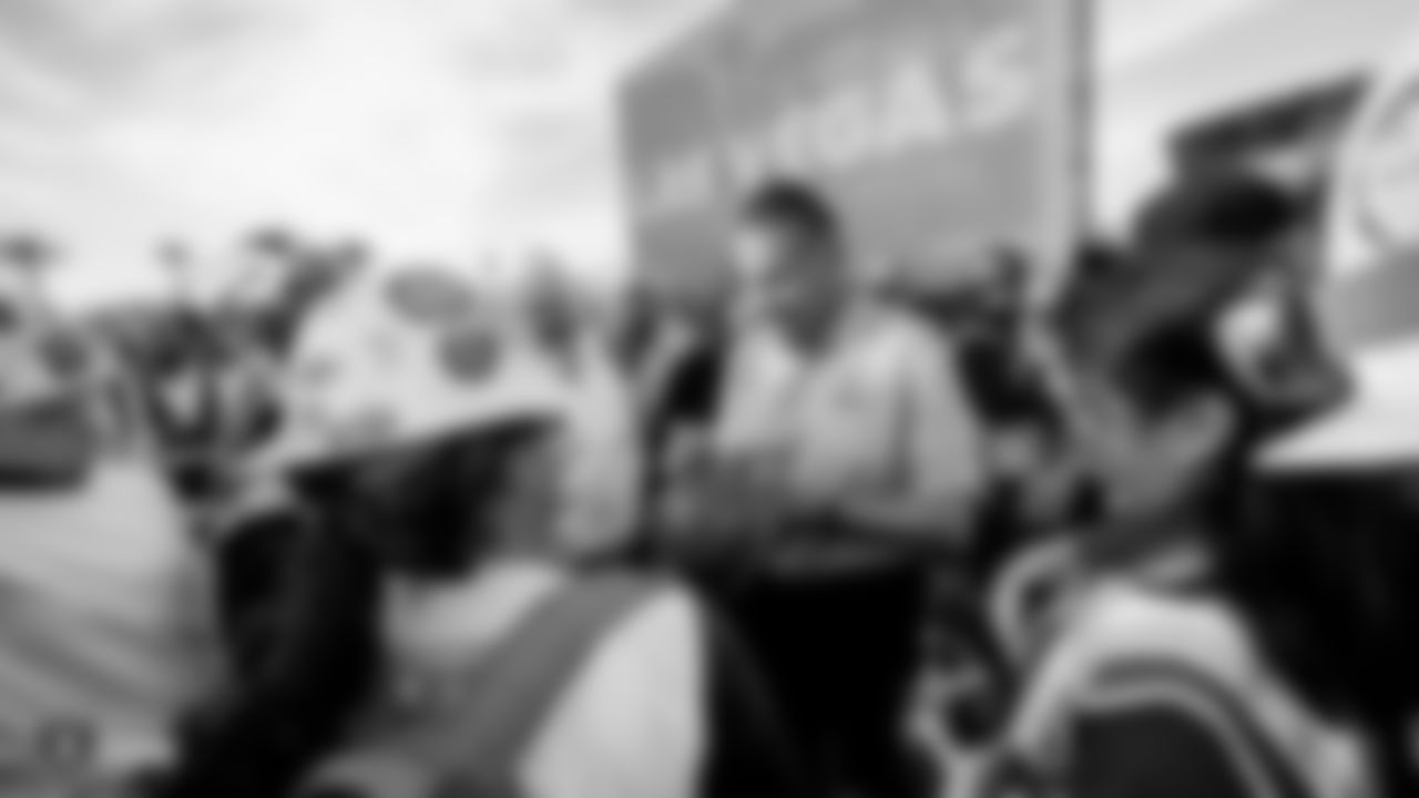 Raiders alumnus Jim Plunkett signs autographs for construction workers following an official announcement of the Raiders changing their name to the Las Vegas Raiders.