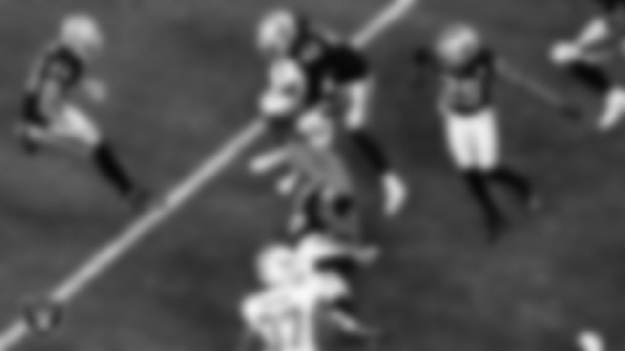 Las Vegas Raiders cornerback Nevin Lawson (26) and linebacker Cory Littleton (42) make a tackle during the regular season home game against the Miami Dolphins.