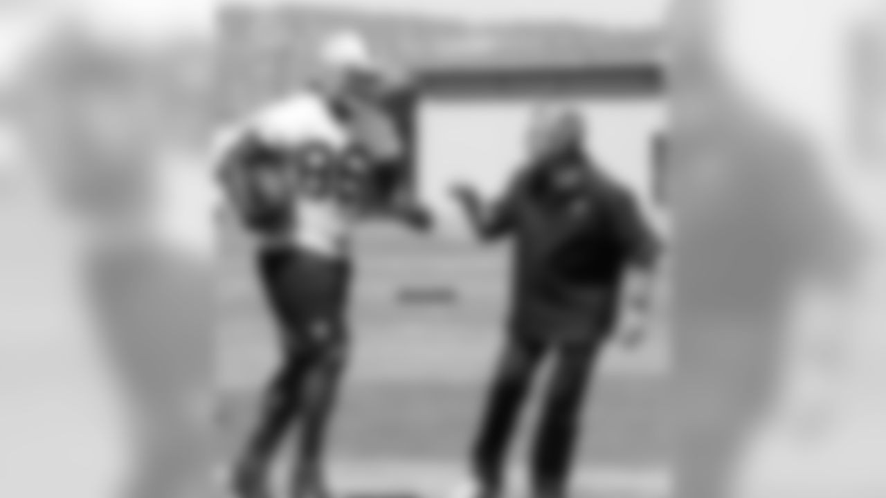 TE David Ausberry is met by senior offensive assistant Al Saunders after a catch.