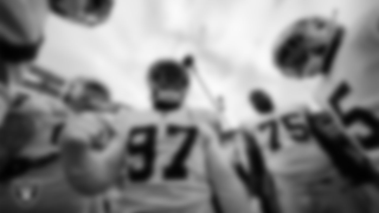 Las Vegas Raiders defensive tackle Damion Square (97) fires the team up in a huddle during warm ups before the postseason away game against the Cincinnati Bengals.
