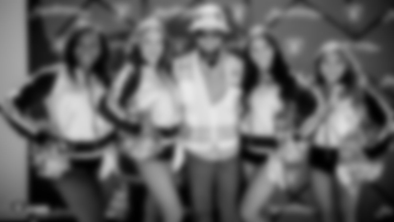 The Raiderettes pose for a photo with a construction worker during a special lunch at the Henderson Headquarters worksite.