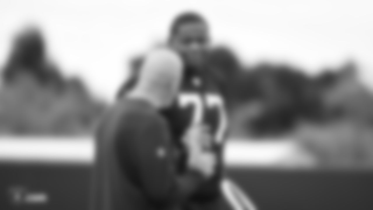Raiders offensive line coach Tom Cable and tackle Trent Brown (77) on the field for practice.