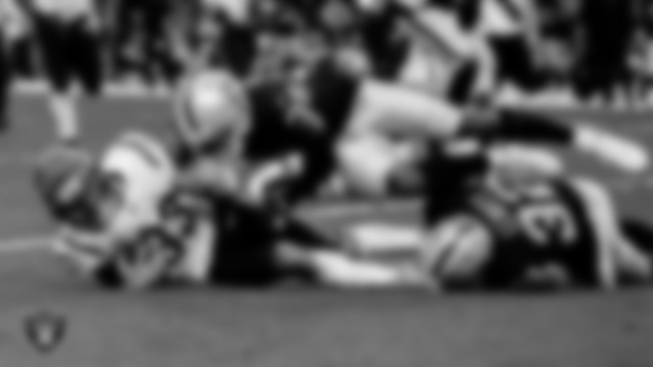 Las Vegas Raiders cornerback Brandon Facyson (35) and safety Dallin Leavitt (32) make a tackle during the regular season home game against the Cincinnati Bengals.