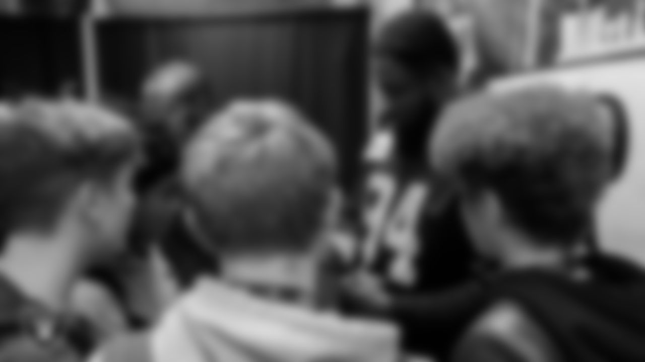 Las Vegas Raiders defensive tackle Matthew Butler (94) signs autographs during the Hip Hop Entrepreneurship class.