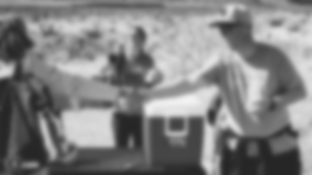 ]The Las Vegas Raiders Family Association members prepare for a hike around Red Rock Canyon.