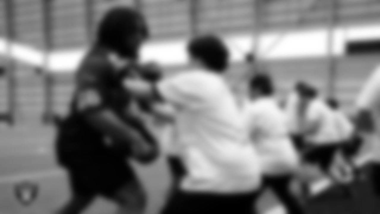 Las Vegas Raiders guard Dylan Parham (66) works with an athlete as they participate in drills during the ELITE Academy at Las Vegas Raiders Headquarters.