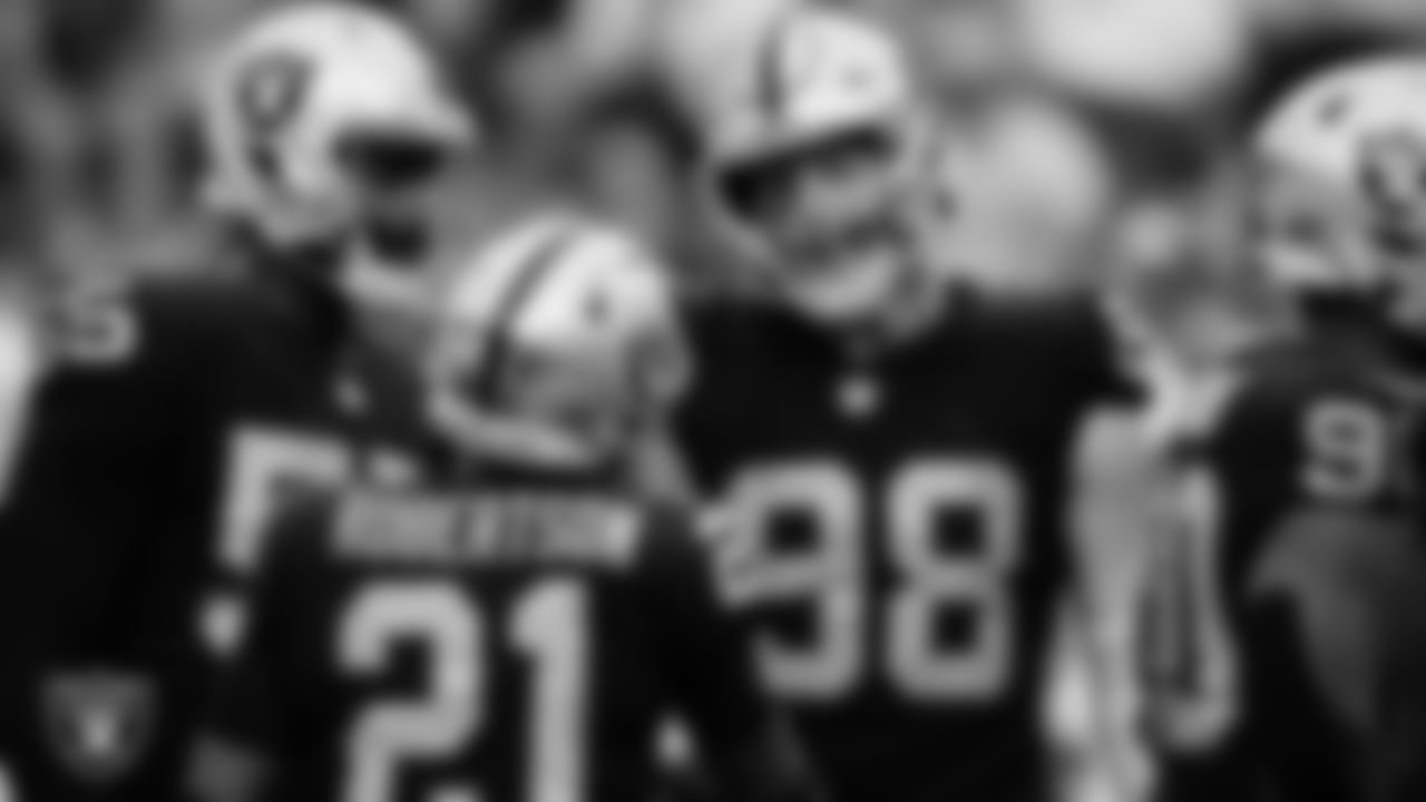Las Vegas Raiders cornerback Amik Robertson (21) is congratulated by defensive end Maxx Crosby (98) after returning a fumble for a 68-yard touchdown during the regular season home game against the Denver Broncos at Allegiant Stadium.
