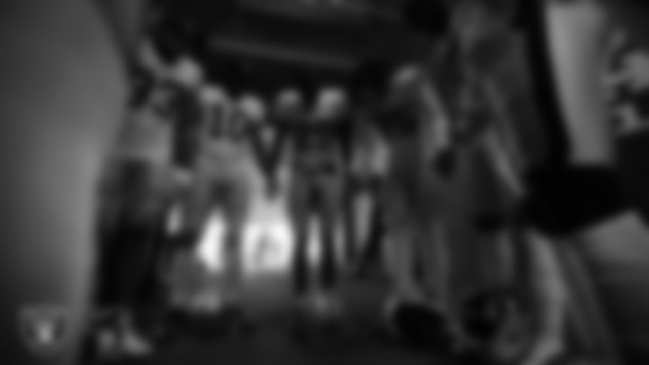 The Las Vegas Raiders defensive backs huddle in the tunnel before the regular season away game against the Kansas City Chiefs at Arrowhead Stadium.