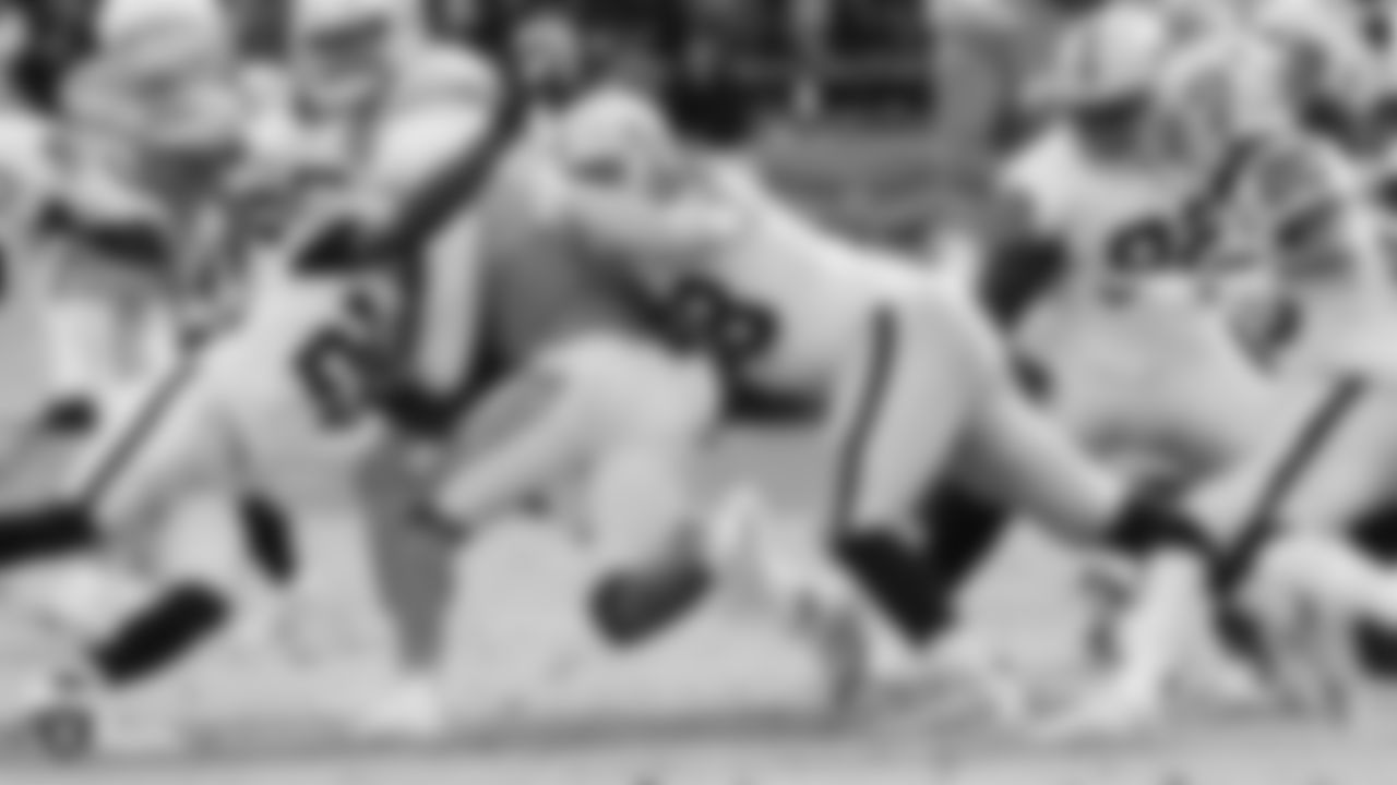 Raiders defensive end Maxx Crosby (98) makes a tackle during the regular season game against the Los Angeles Chargers.