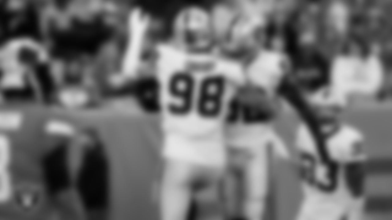 Las Vegas Raiders defensive end Maxx Crosby (98) and linebacker Denzel Perryman (52) during the regular season away game against the Denver Broncos at Empower Field at Mile High.