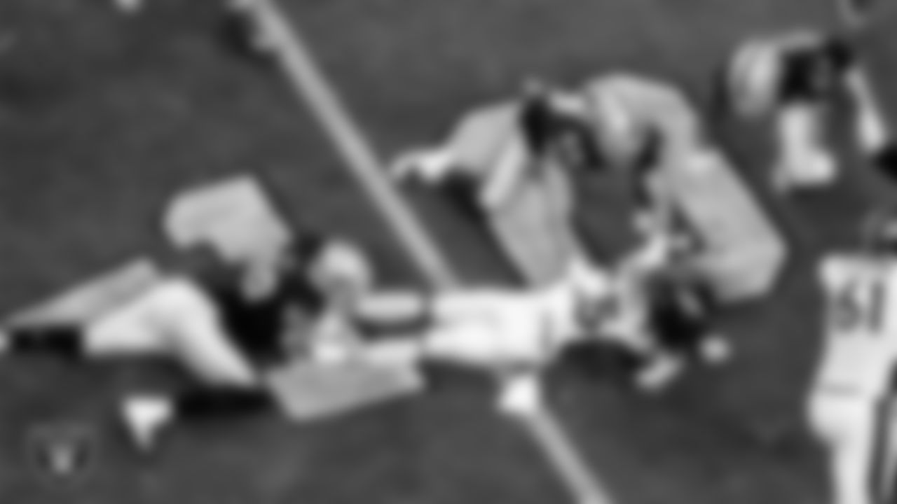 Las Vegas Raiders defensive end Arden Key (99) and linebacker Nick Kwiatkoski (44) make a tackle during the regular season home game against the Denver Broncos.
