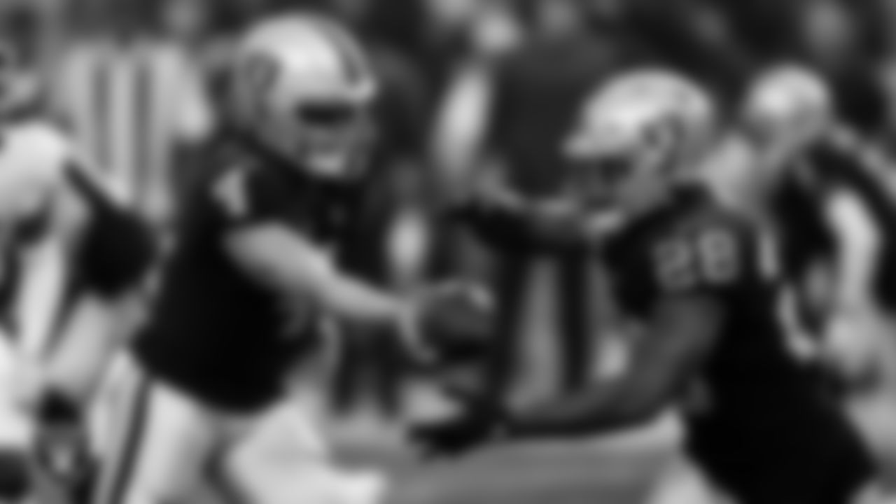 Las Vegas Raiders quarterback Derek Carr (4) hands the ball off to running back Josh Jacobs (28) during the regular season home game against the Washington Football Team.