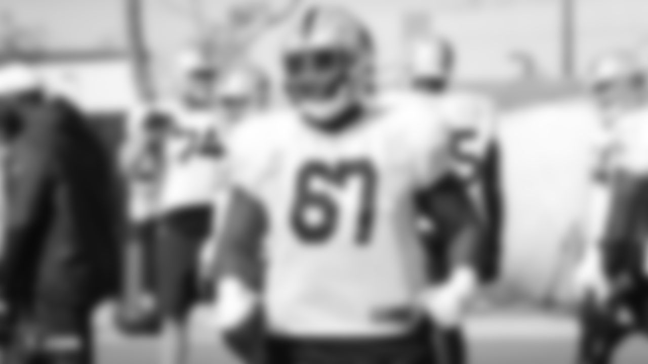 Raiders guard Lester Cotton Sr. (67) stands on the field during practice.