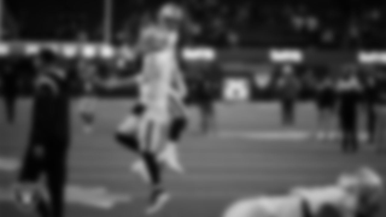 Las Vegas Raiders quarterback Derek Carr (4) and defensive end Maxx Crosby (98) warming up before the regular season away game against the Los Angeles Rams at SoFi Stadium.