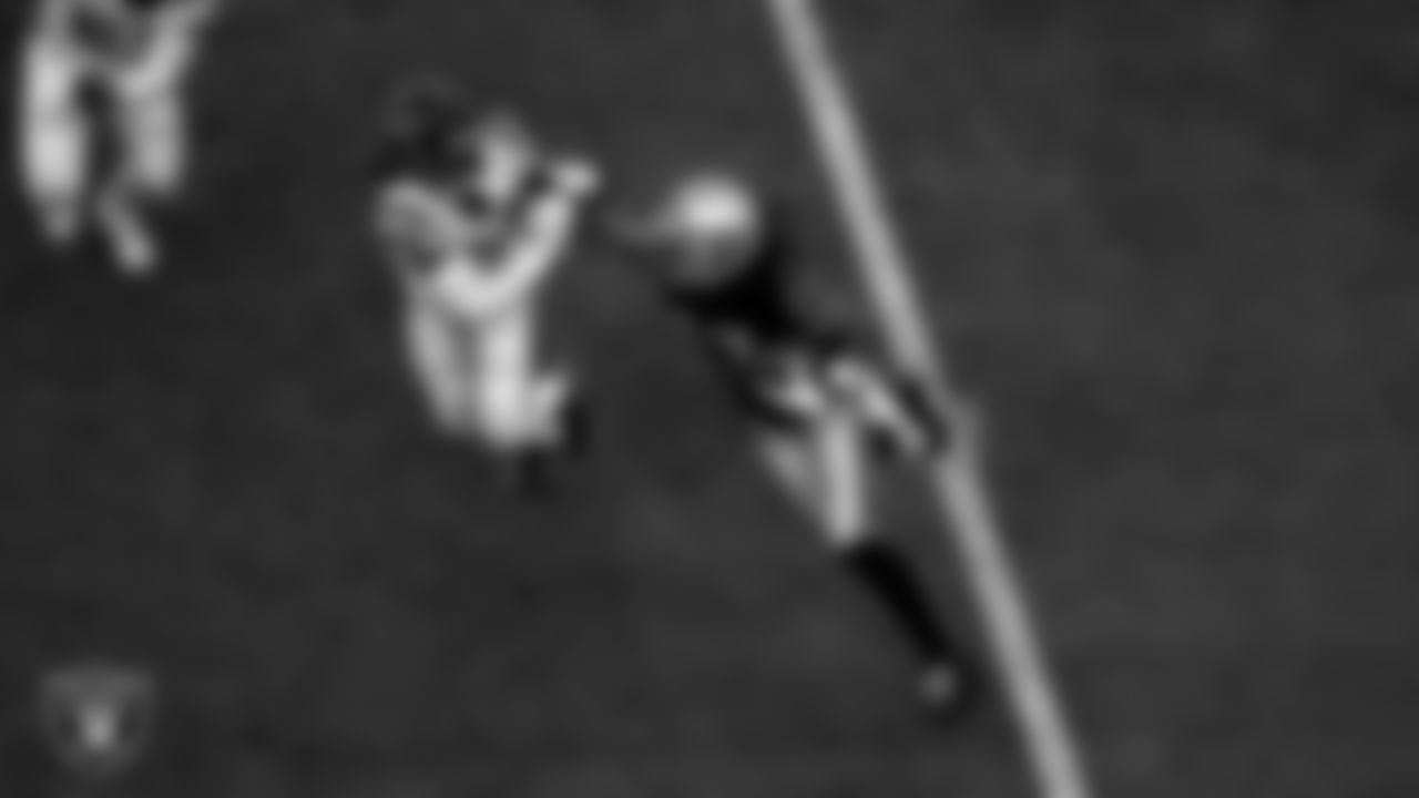 Las Vegas Raiders wide receiver Davante Adams (17) stiff arms the defender during the regular season home game against the Houston Texans at Allegiant Stadium.