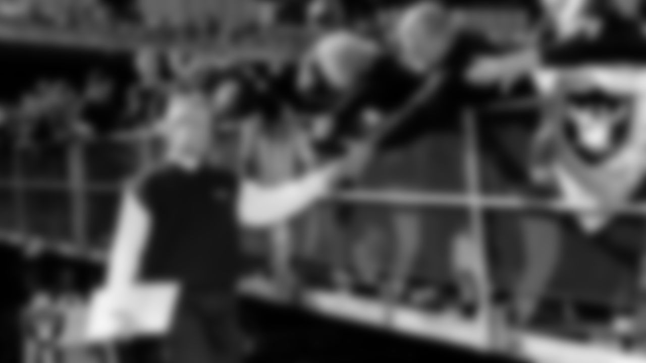 Raiders Head Coach Jon Gruden with fans before a game in 2000.
