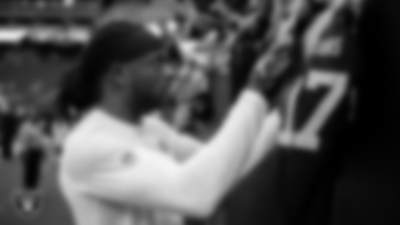 Las Vegas Raiders wide receiver Davante Adams (17) signs autographs for fans before the regular season home game against the Denver Broncos at Allegiant Stadium.