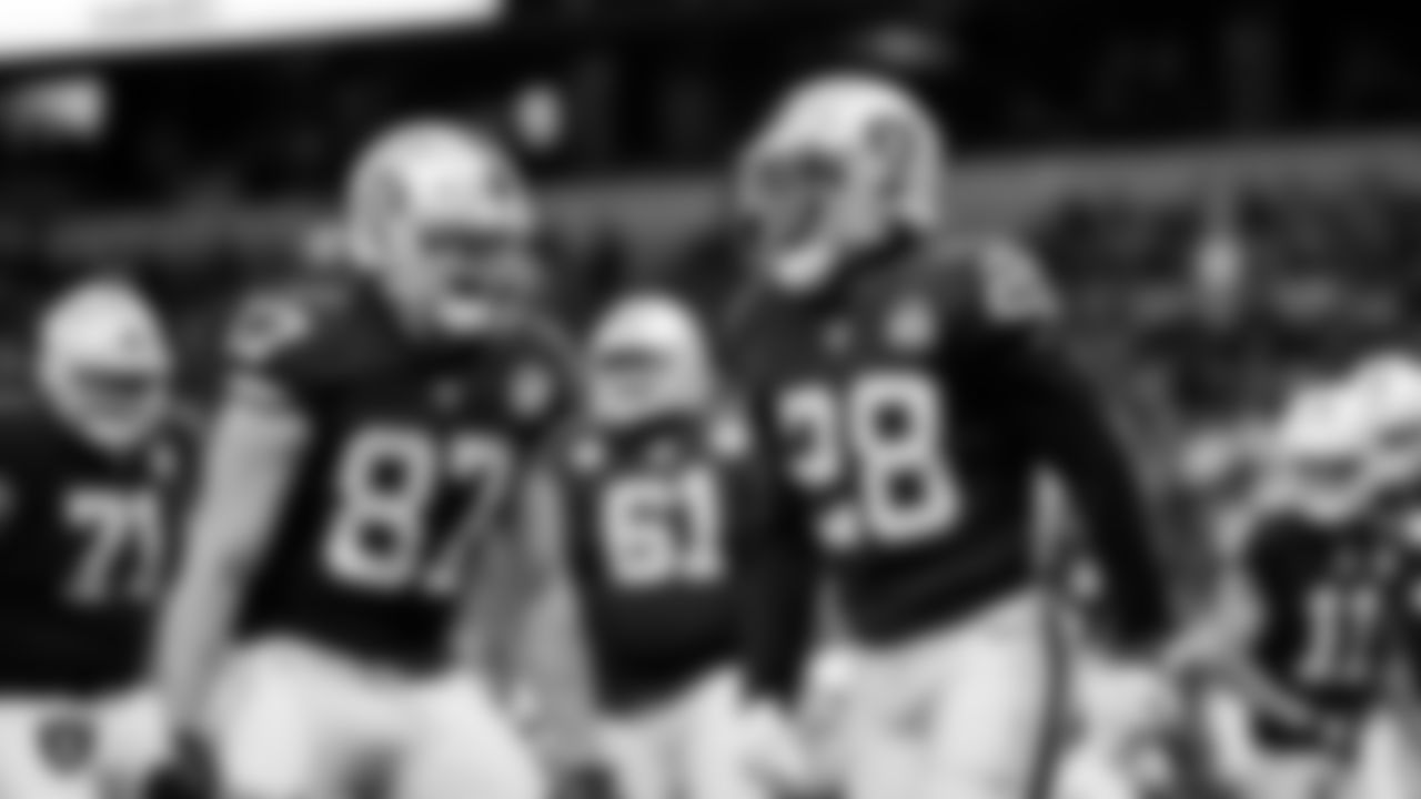 Raiders running back Josh Jacobs (28) and tight end Foster Moreau (87) celebrate after rushing for a 12-yard touchdown during the game against the Chicago Bears at Tottenham Hotspur Stadium.