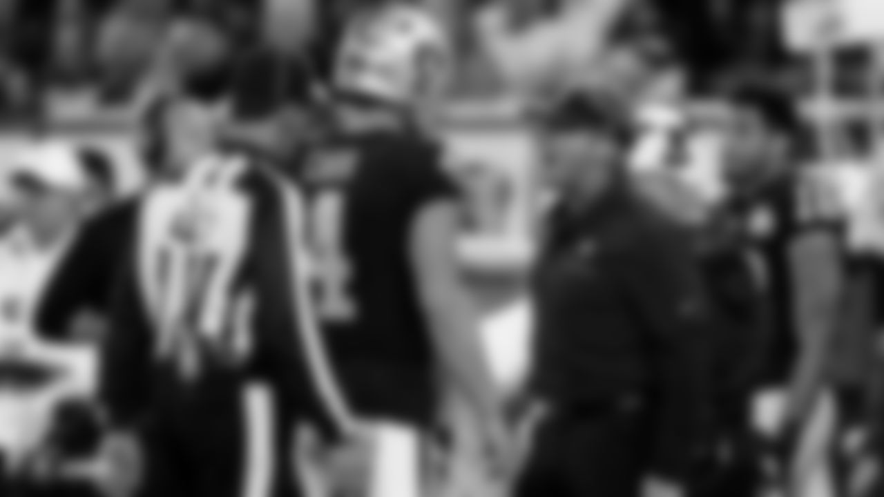 Raiders quarterback Derek Carr (4) talks with Head Coach Jon Gruden during the regular season game against the Chicago Bears at Tottenham Hotspur Stadium.