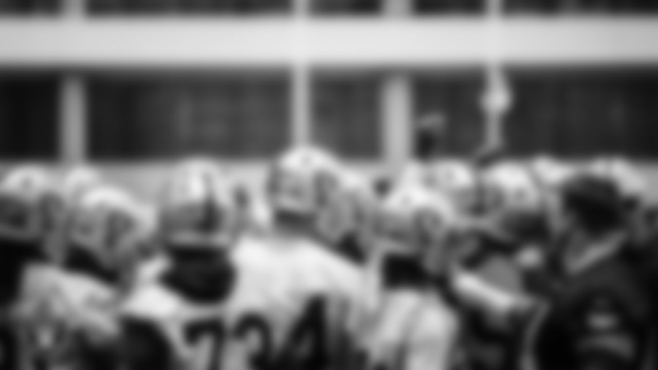 Las Vegas Raiders players and coaches huddle during practice.