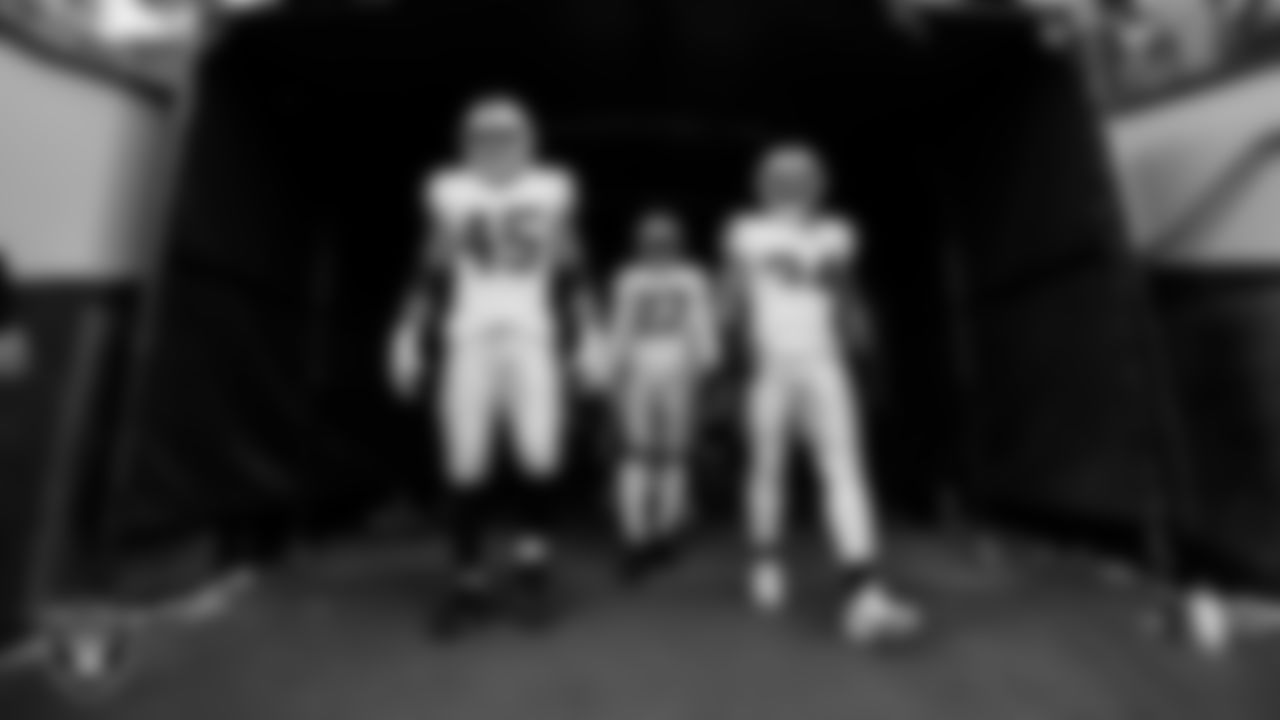 Las Vegas Raiders fullback Jakob Johnson (45), cornerback Sam Webb (27) and running back Brandon Bolden (34) walk down the tunnel before the regular season away game against the Denver Broncos at Empower Field at Mile High.