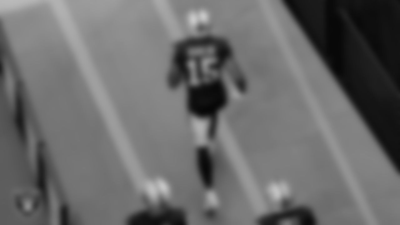 The Raiders walk down the tunnel before the regular season game against the Denver Broncos at Allegiant Stadium.