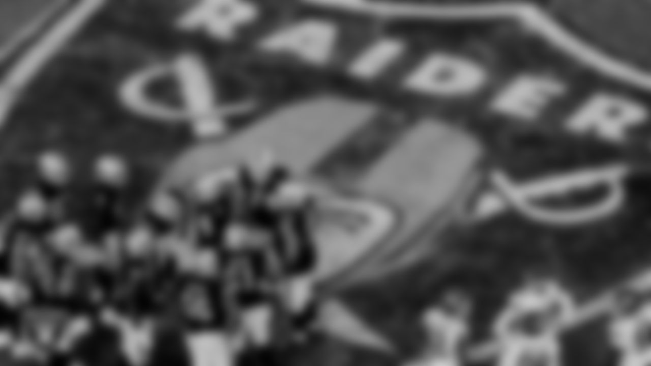 The Las Vegas Raiders offense huddles during the regular season game against the Kansas City Chiefs at Allegiant Stadium.