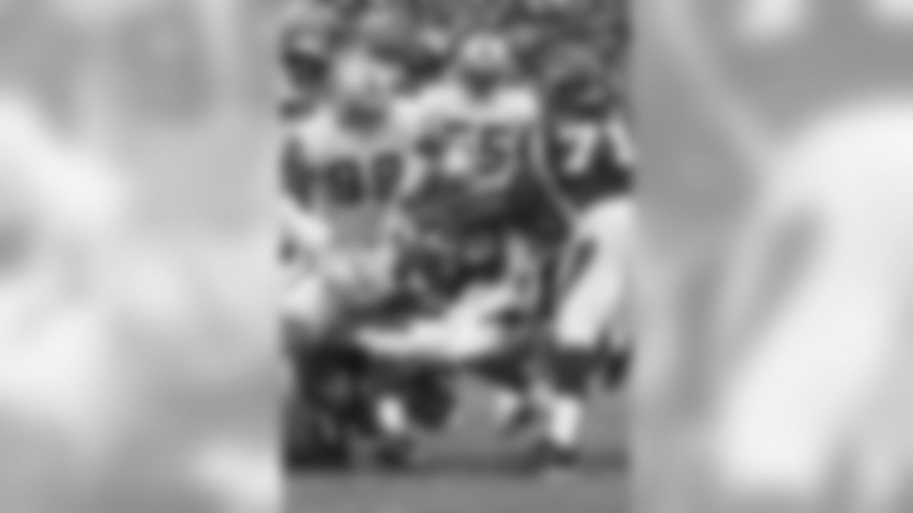 The Raiders defense swarms Adrian Peterson.