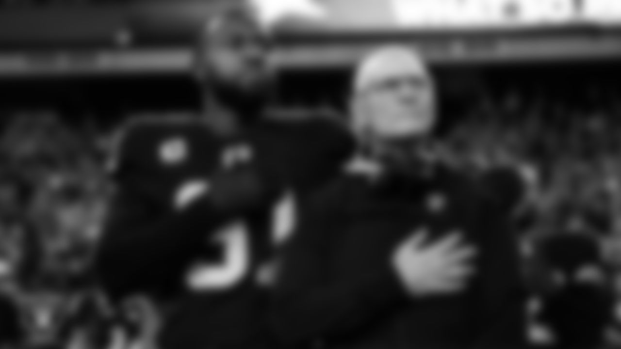 Las Vegas Raiders defensive end Yannick Ngakoue (91) and defensive line coach Rod Marinelli during the national anthem before the regular season home game against the Los Angeles Chargers.