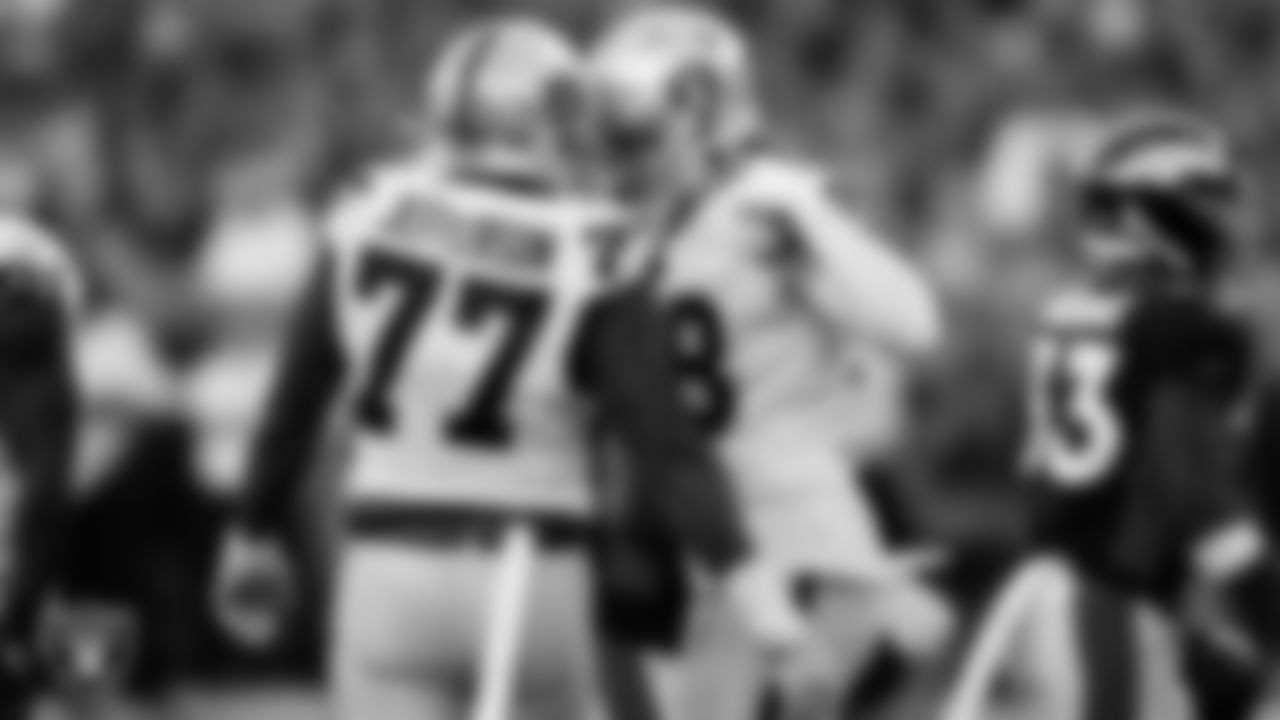 Las Vegas Raiders defensive tackle Quinton Jefferson (77) and defensive end Maxx Crosby (98) celebrate during the regular season away game against the Denver Broncos.