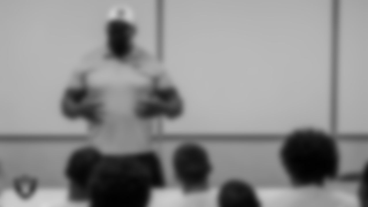 Las Vegas Raiders alumnus Roy Hart talks to the Canyon Springs High School football team.