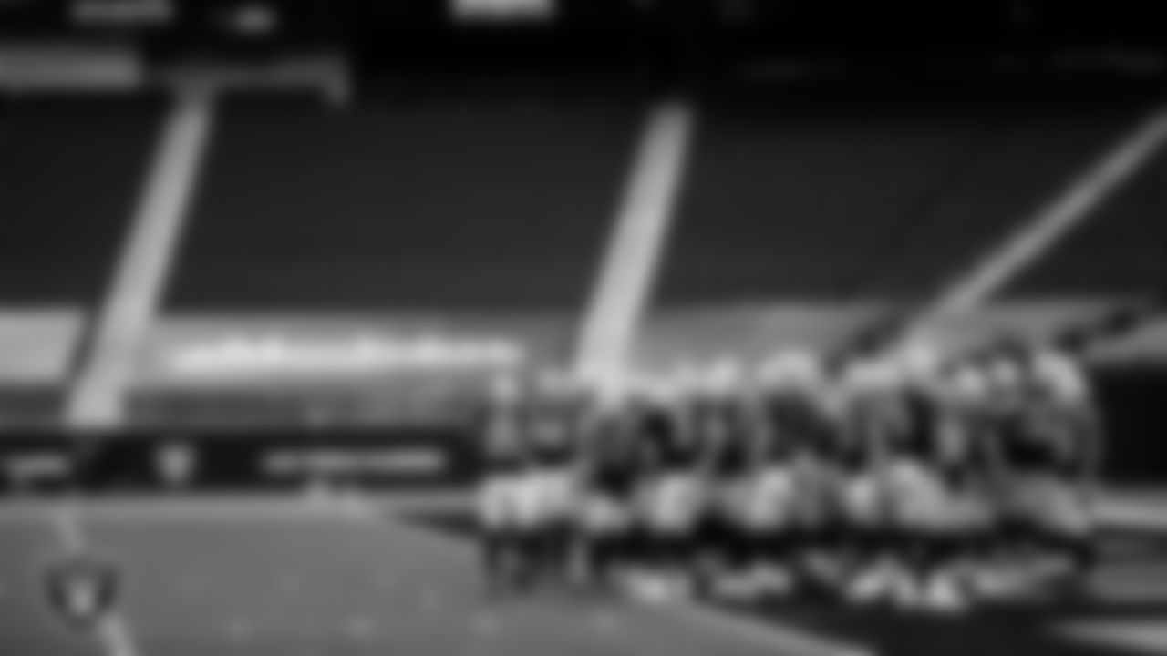 The Las Vegas Raiders huddle before the regular season home game against the Tampa Bay Buccaneers.