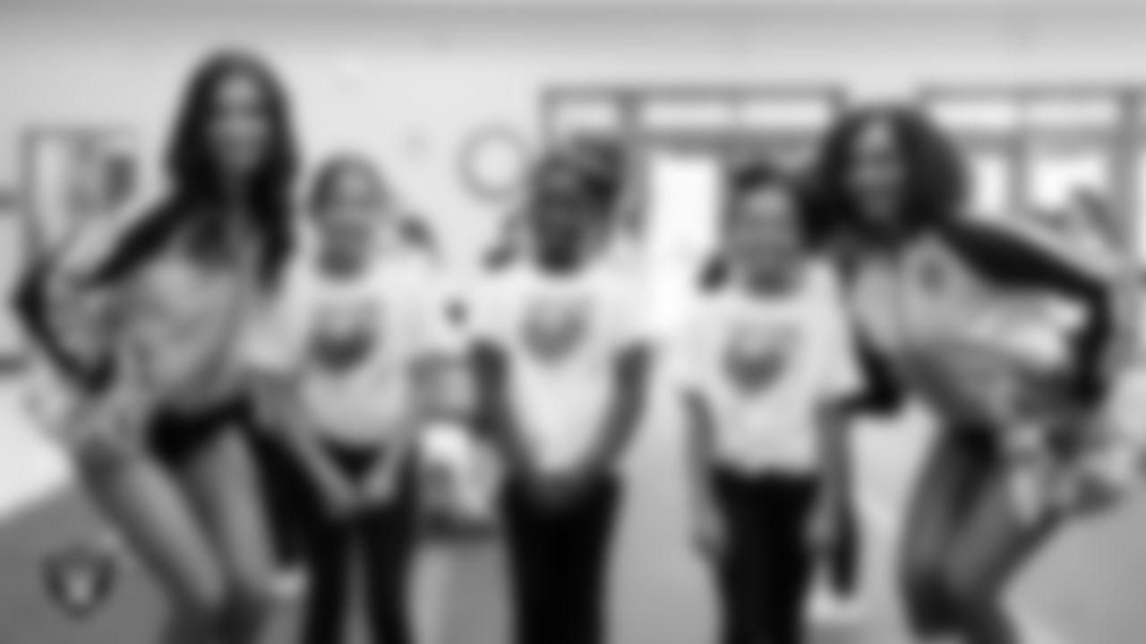 Raiderettes Maddie and Makenna P. pose for a photo with members of the Linda Rankin Givens Elementary cheer team during the holiday pep rally.