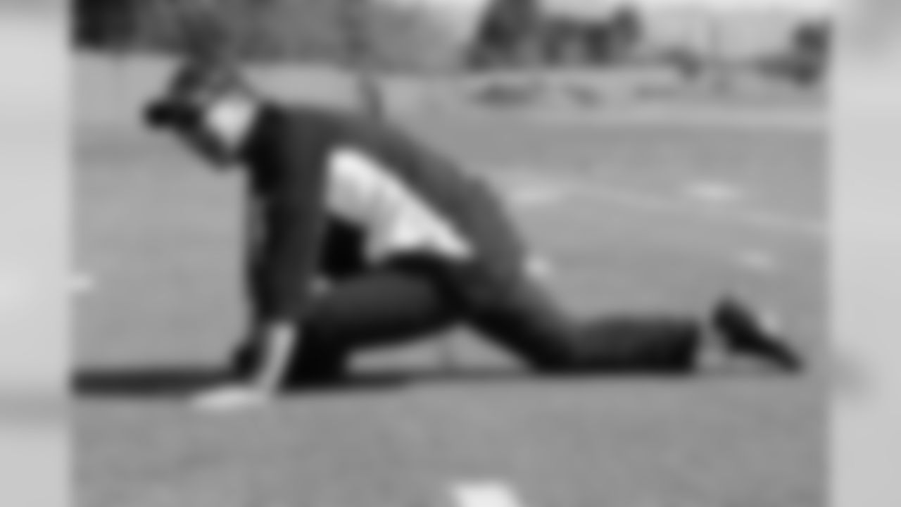 Strength and conditioning coach Brad Roll leads the tream through stretching exercises.