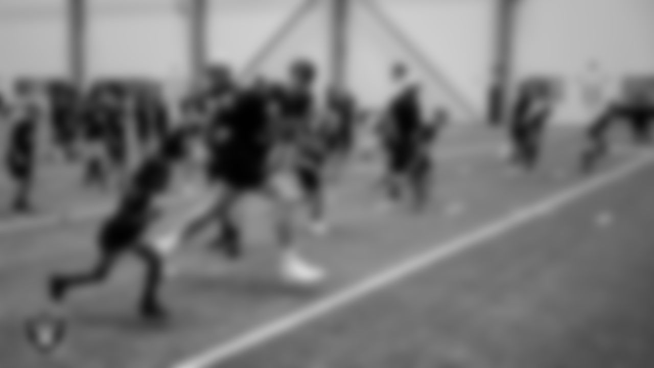 Las Vegas Raiders defensive end Maxx Crosby (98) warms up with an athlete during the Raiders Play Football Skills Camp at Intermountain Health Performance Center.