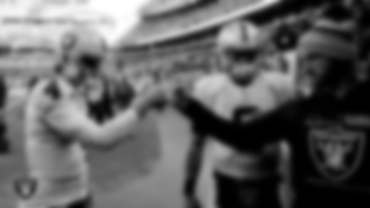 Las Vegas Raiders quarterback Derek Carr (4), quarterback Marcus Mariota (8) and quarterback Nathan Peterman (3) huddle in the tunnel before the regular season away game against the Cleveland Browns.