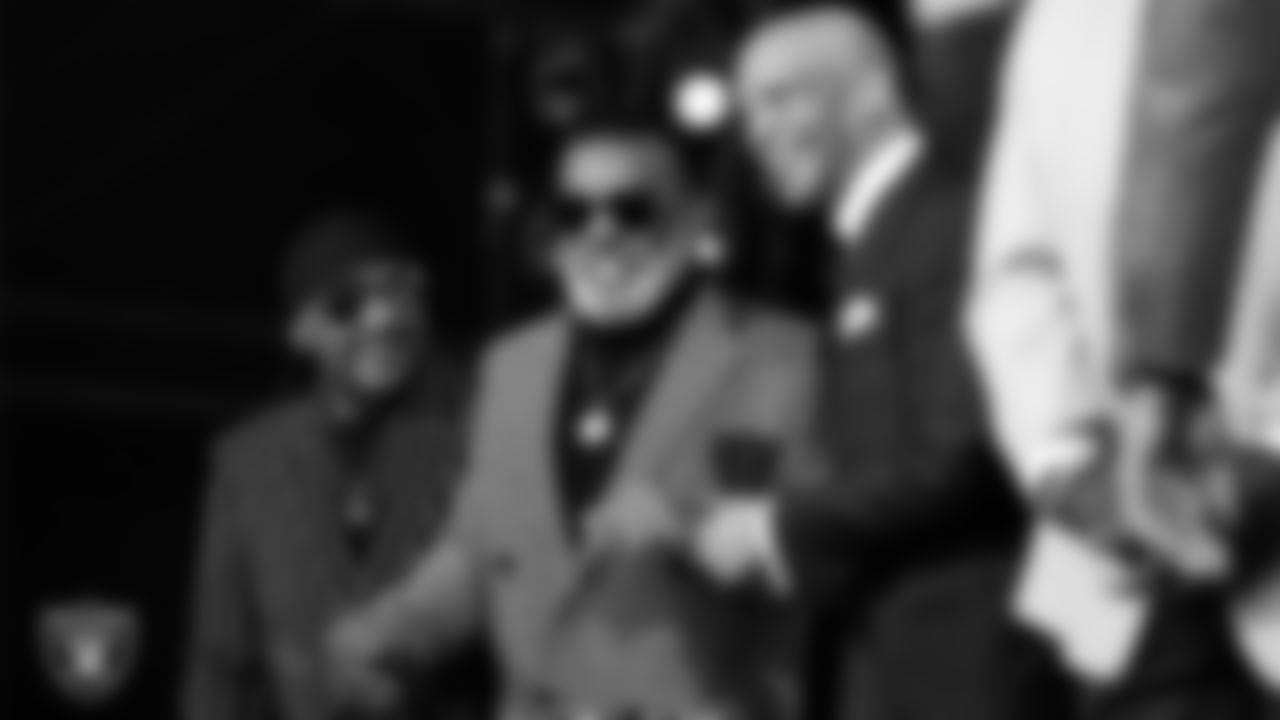 NFL Hall of Famer Drew Pearson stands next to The Isley Brothers on the stage during the 2021 NFL Draft .