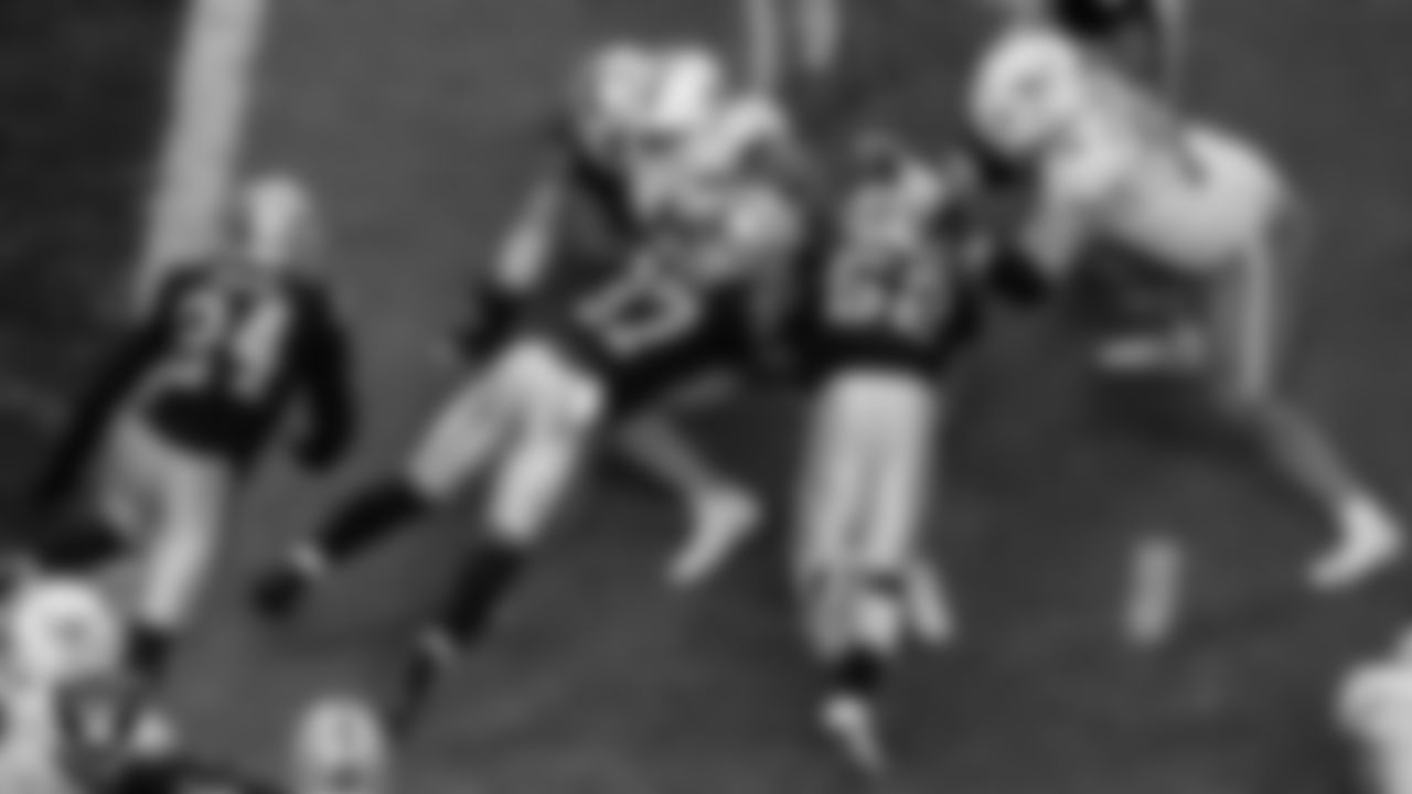 Las Vegas Raiders defensive tackle Darius Philon (96), safety Tyree Gillespie (37) and linebacker Denzel Perryman (52) make a tackle during the regular season home game against the Miami Dolphins.